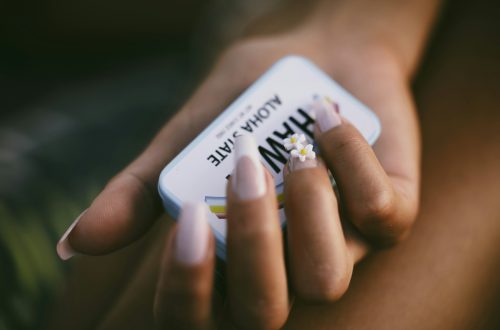a woman's hand holding a cell phone with a message on it